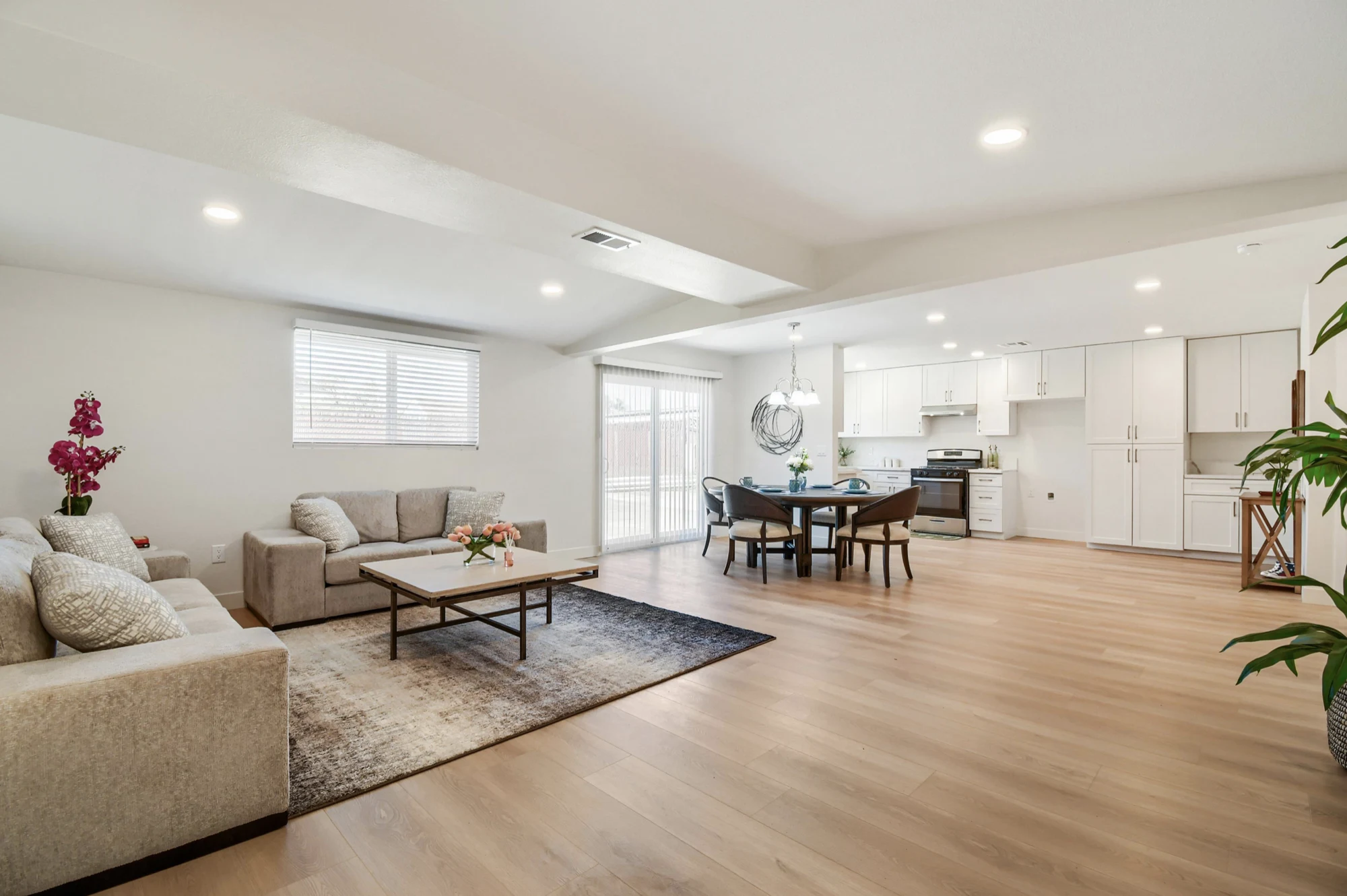 Completed open-plan living room and kitchen with light oak flooring